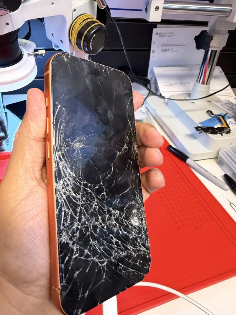 iPhone con la pantalla destrozada antes de ser reparado en Cellifix